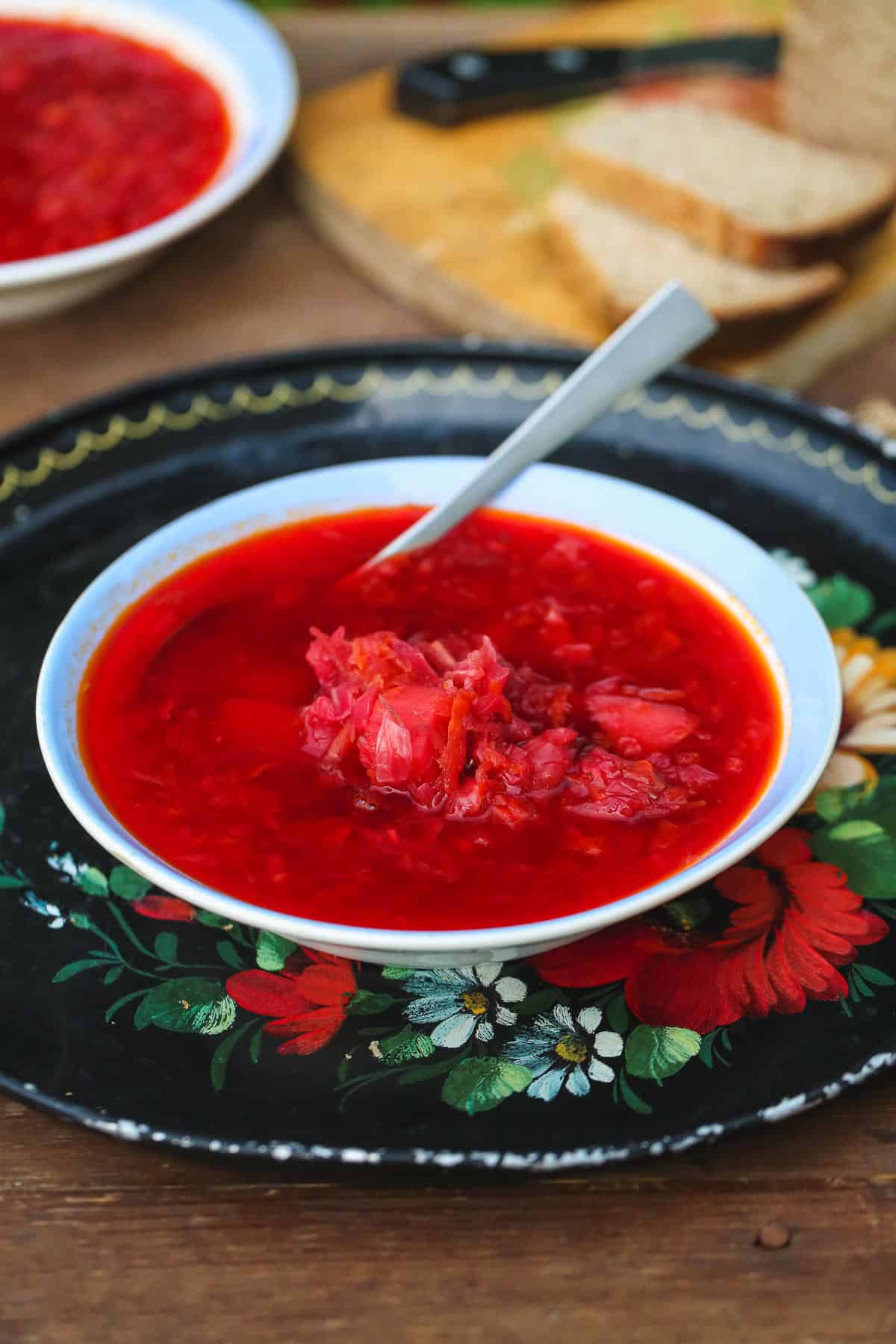 A bowl of Russian Borscht soup placed on a traditional Russian tray