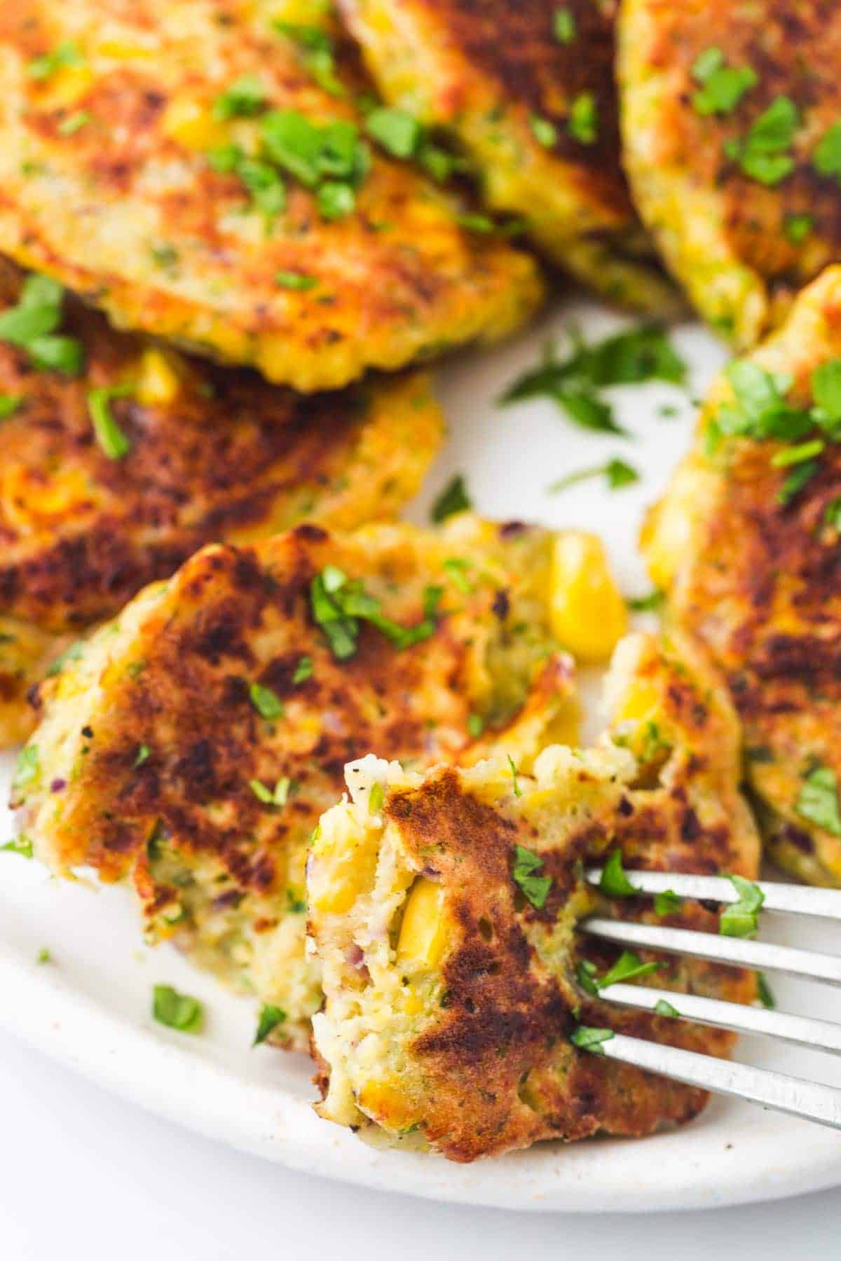 Eating corn fritters with a fork