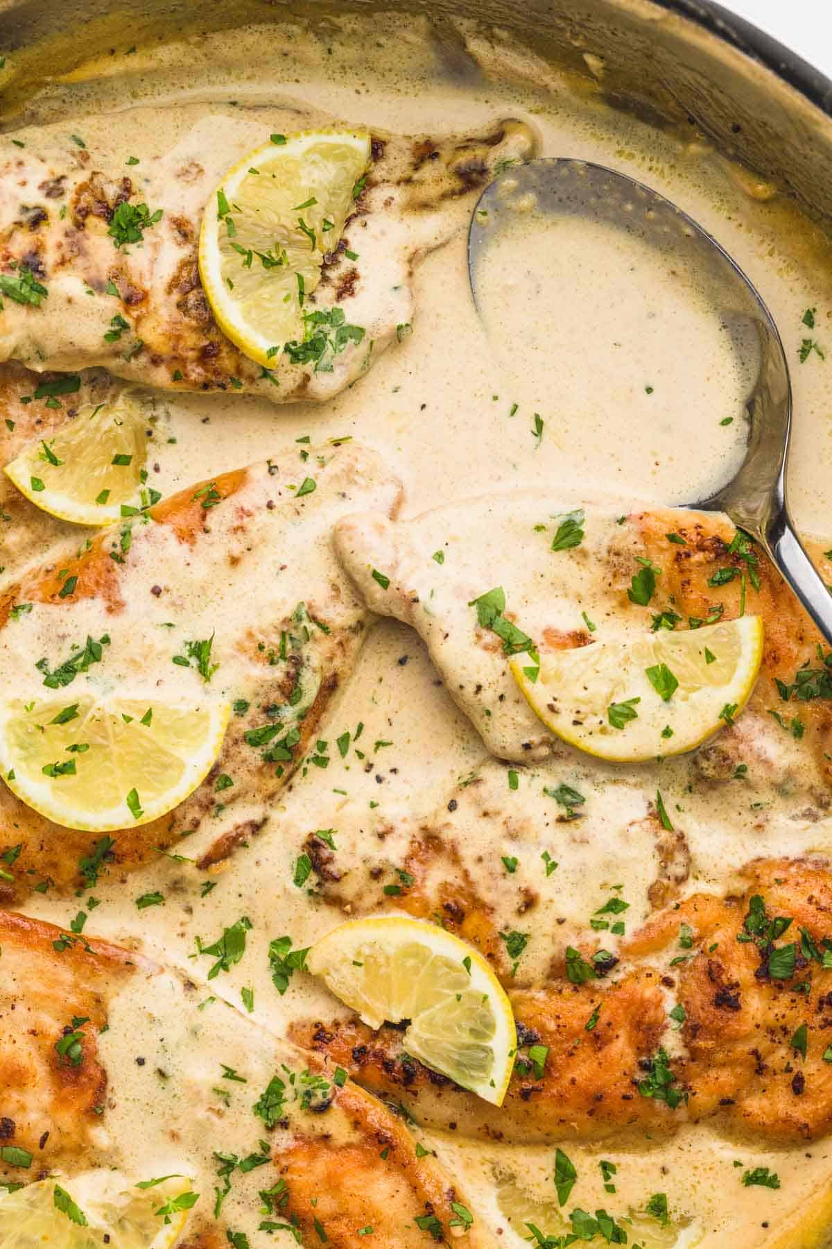 Lemon Chicken in a skillet, and a serving spoon