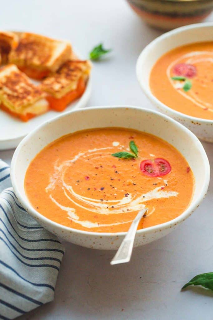 A bowl of instant pot tomato bisque with a spoon