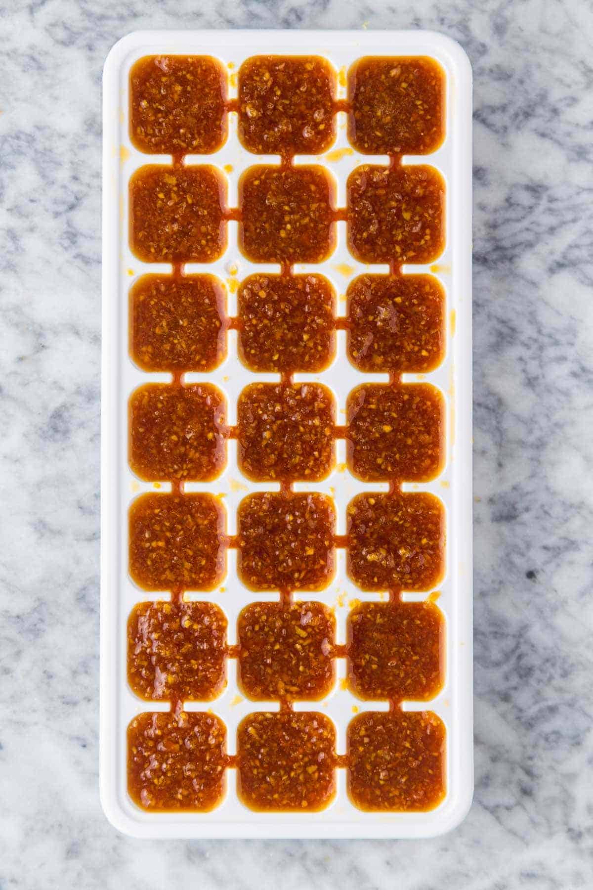 frozen sauce in an ice cube tray