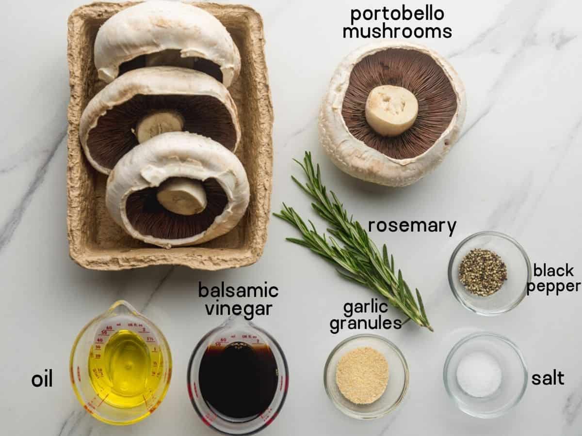Ingredients needed to make Grilled Portobello Mushrooms: mushrooms, rosemary, oil, balsamic vinegar, garlic granules, salt, and pepper.