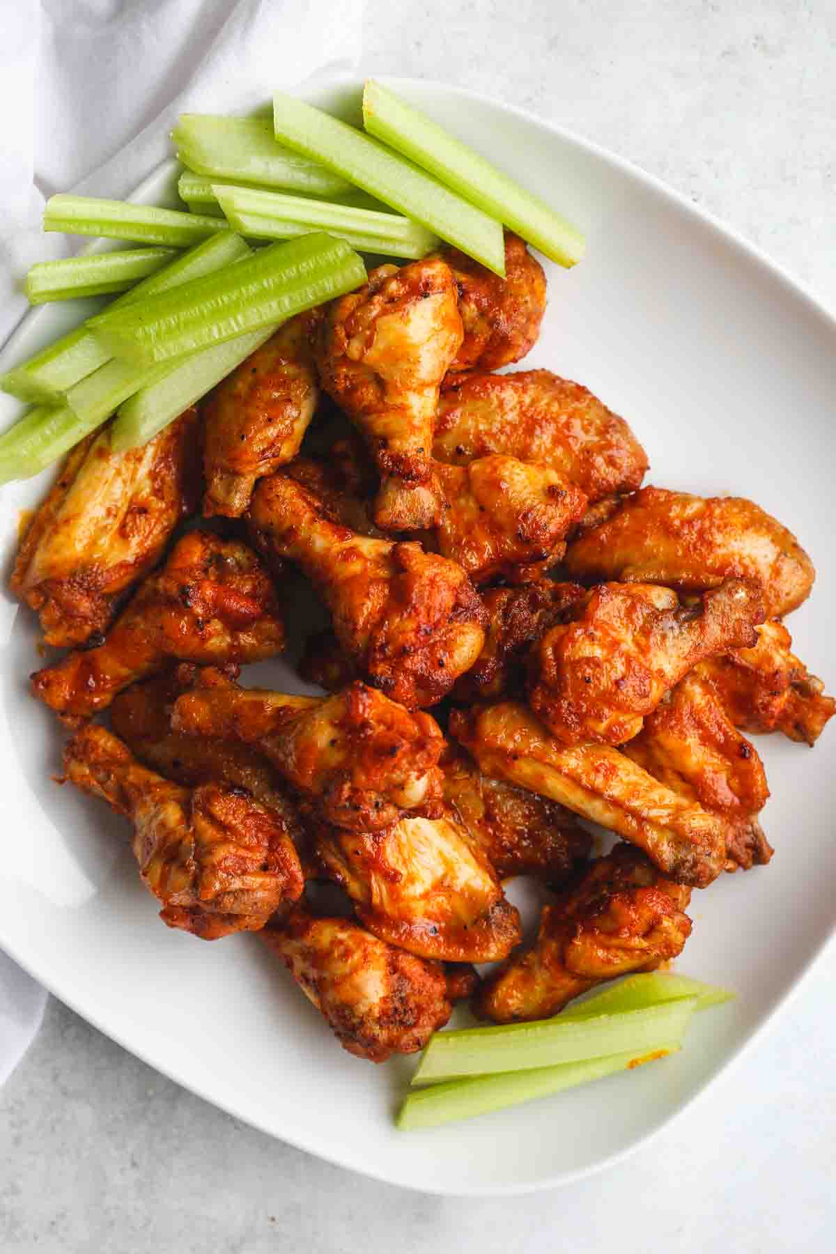 Instant Pot chicken wings served on a white platter with celery sticks