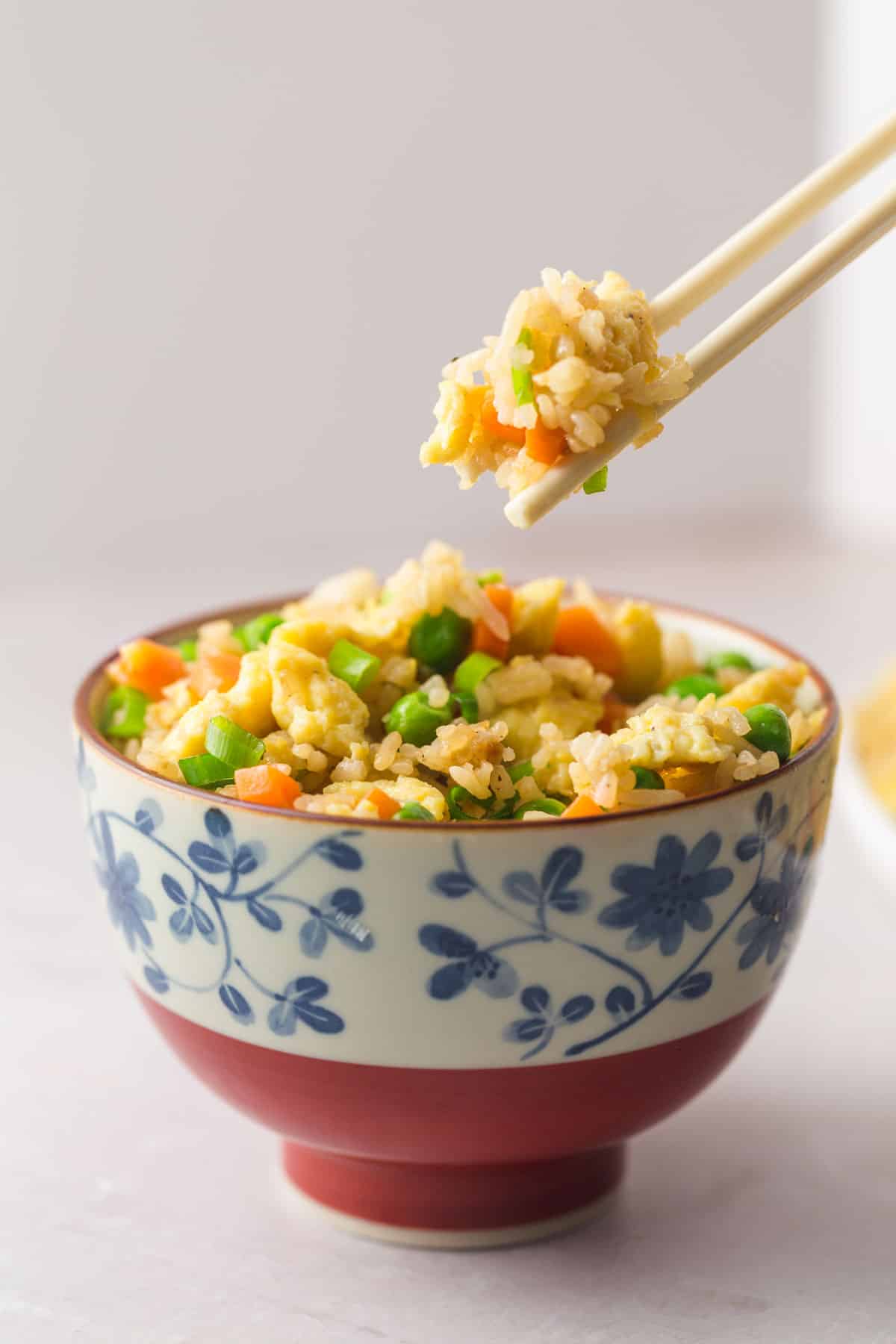 A Japanese traditional bowl with fried rice, and chop sticks