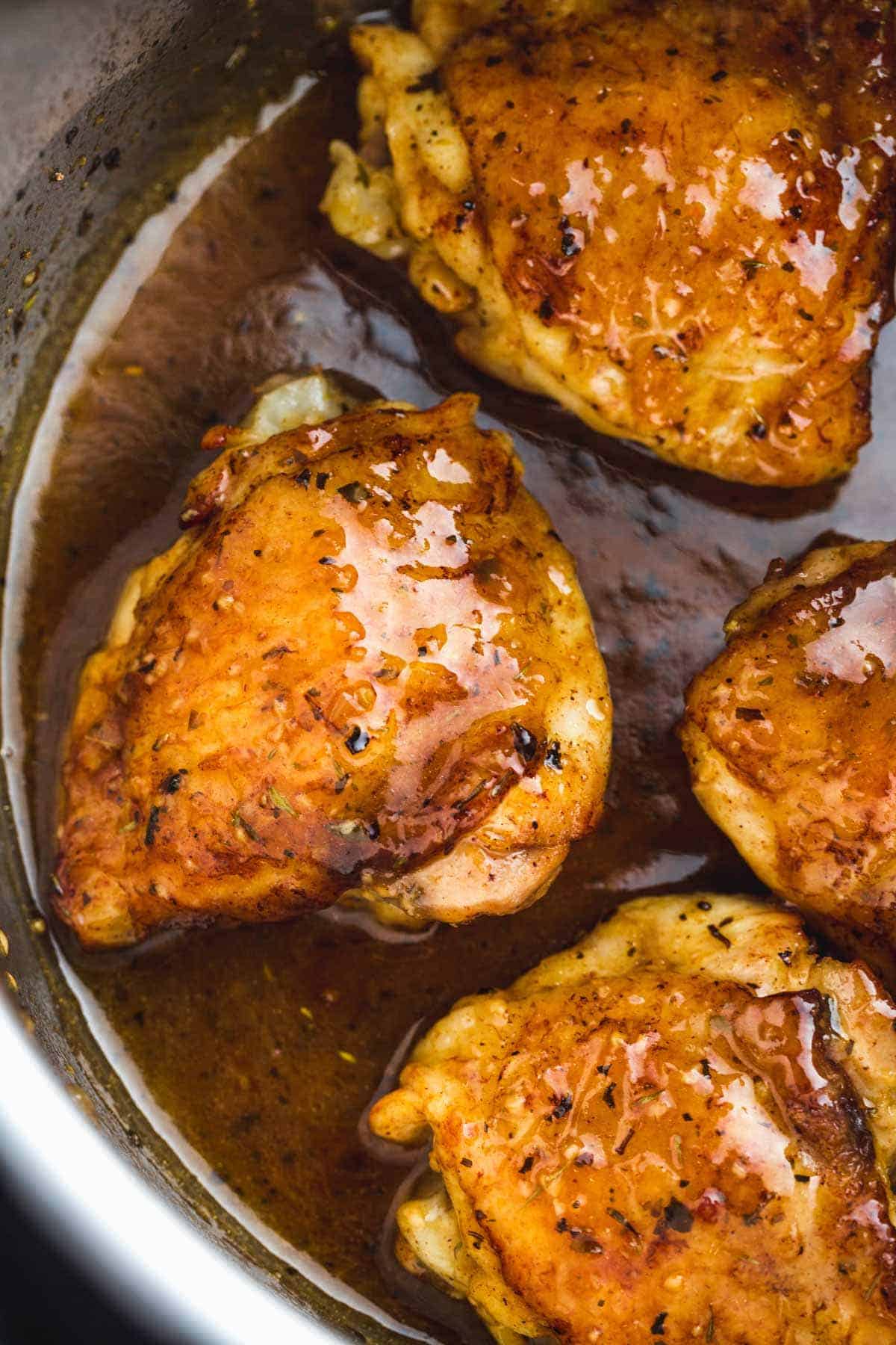 Close up of glazed brown sugar chicken thighs in the Instant Pot