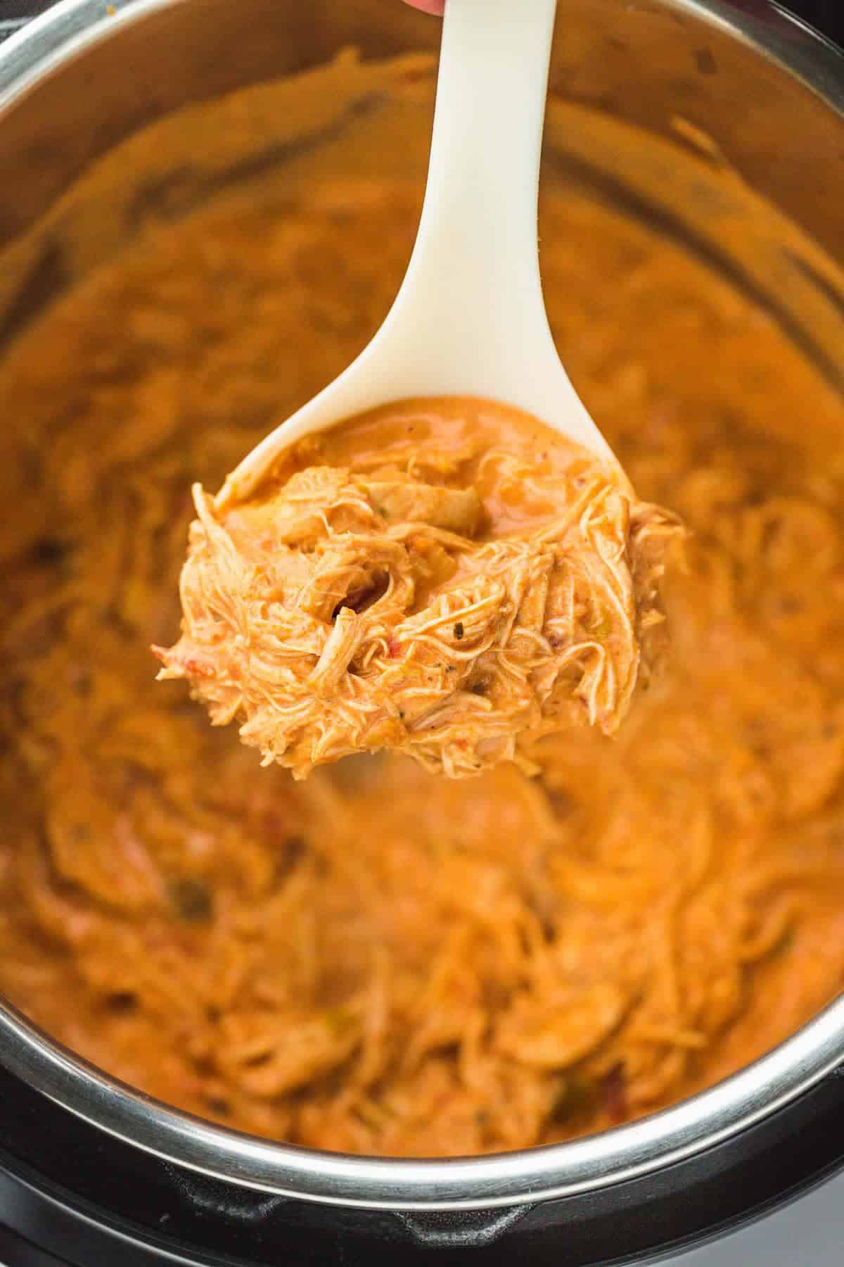 creamy salsa chicken in the instant pot in a serving spoon