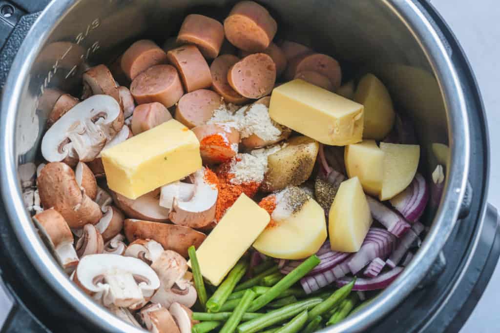 Instant Pot Sausage and Potatoes ingredients in the Instant Pot before cooking