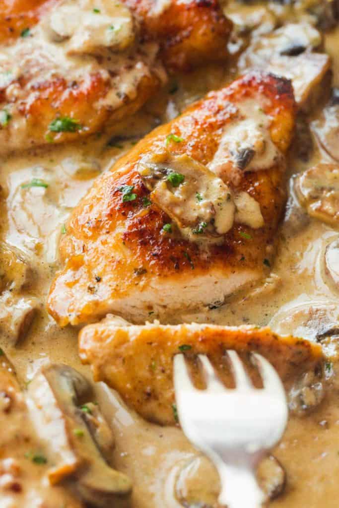 Cutting through the Instant Pot marsala chicken breast to show the doneness of the chicken