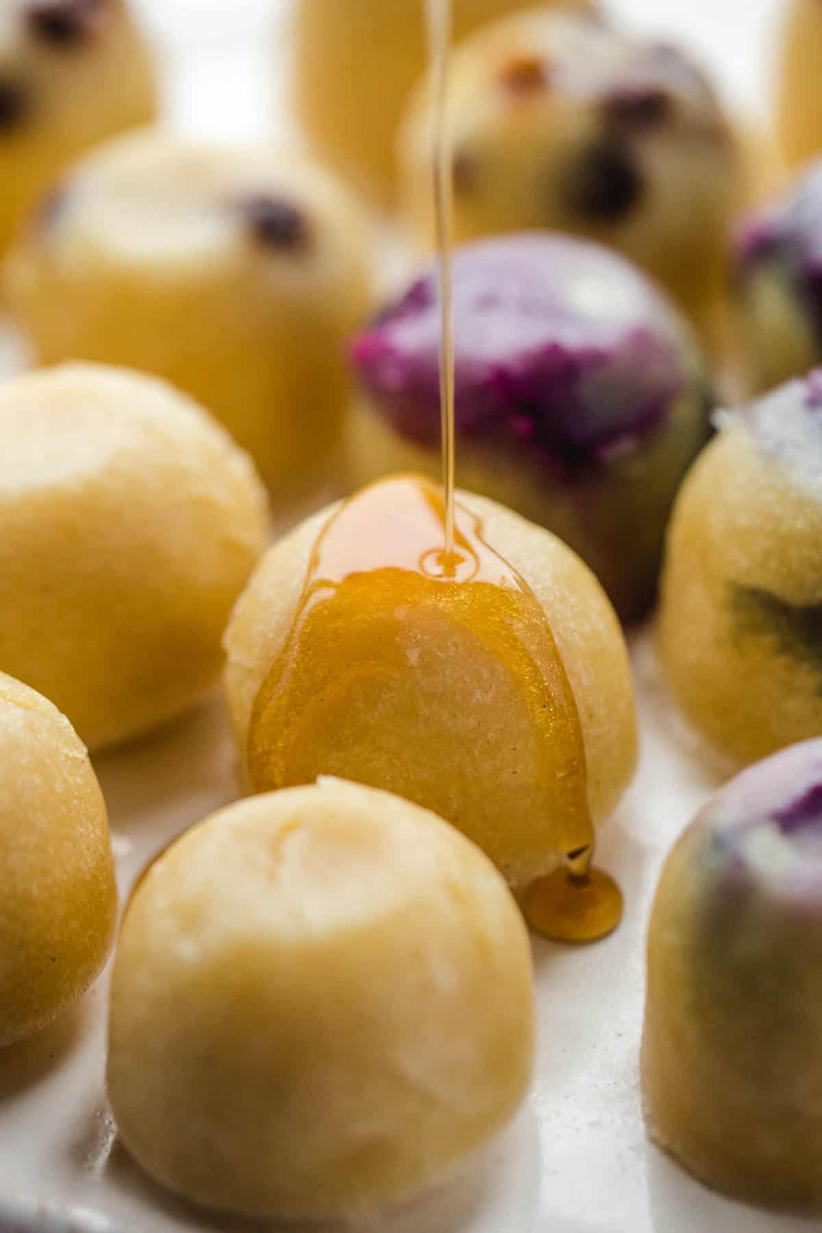 Drizzling pancake syrup over pancake bites made in the instant pot