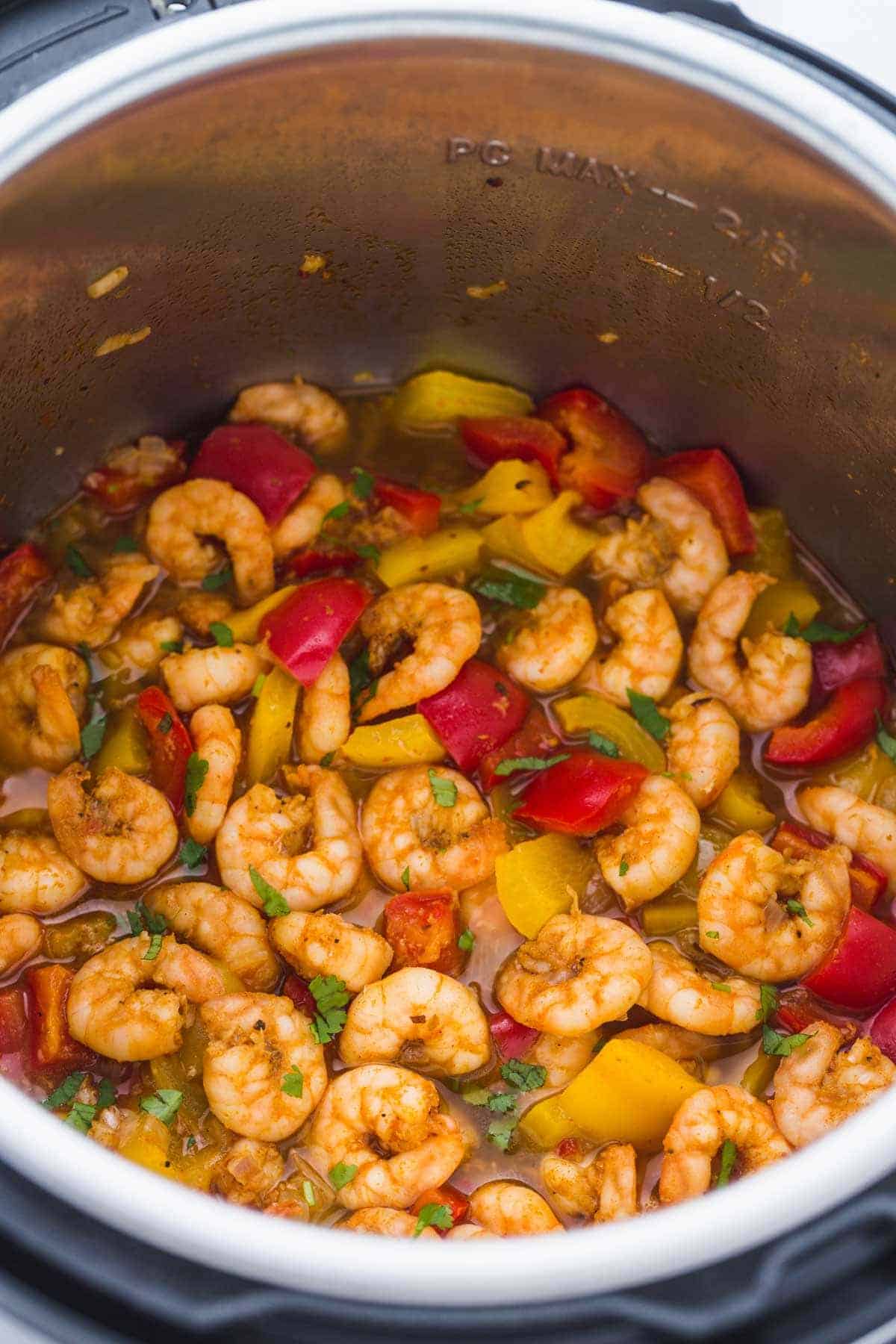Spicy Cajun Pepper Shrimp garnished with fresh parsley leaves in the Instant Pot