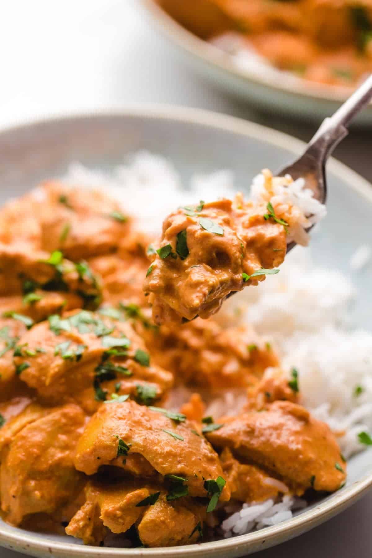 Eating chicken tikka masala with a fork