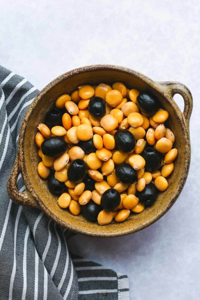 A bowl with Italian Lupini beans and black pitted olives