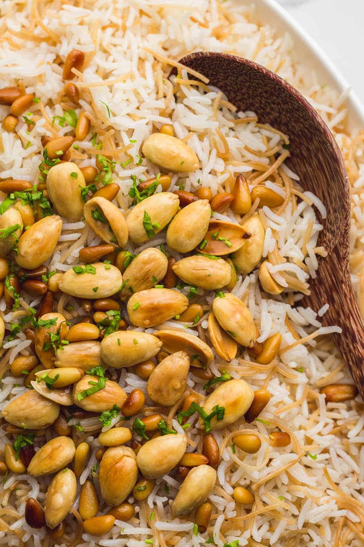 Lebanese rice a.k.a Vermicelli rice with toasted nuts, and wooden serving spoon