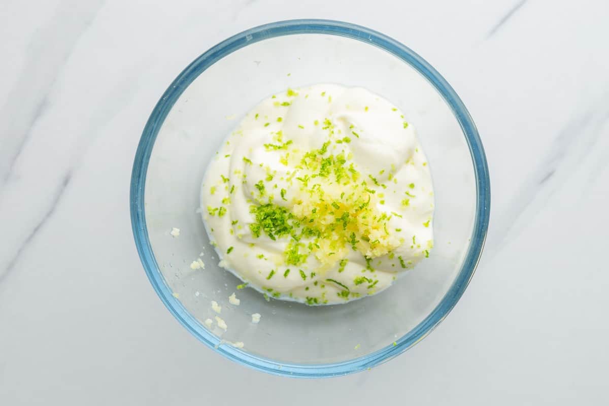 Lime crema ingredients in a glass Pyrex bowl