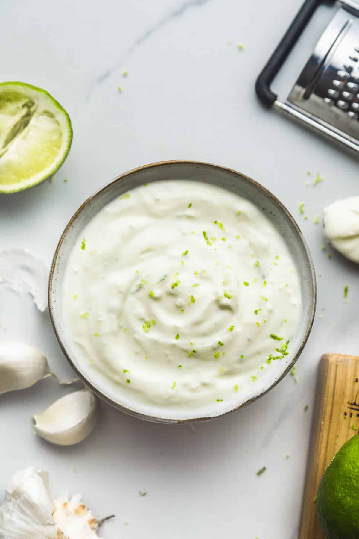 Lime Crema in a bowl garnished with lime zest.