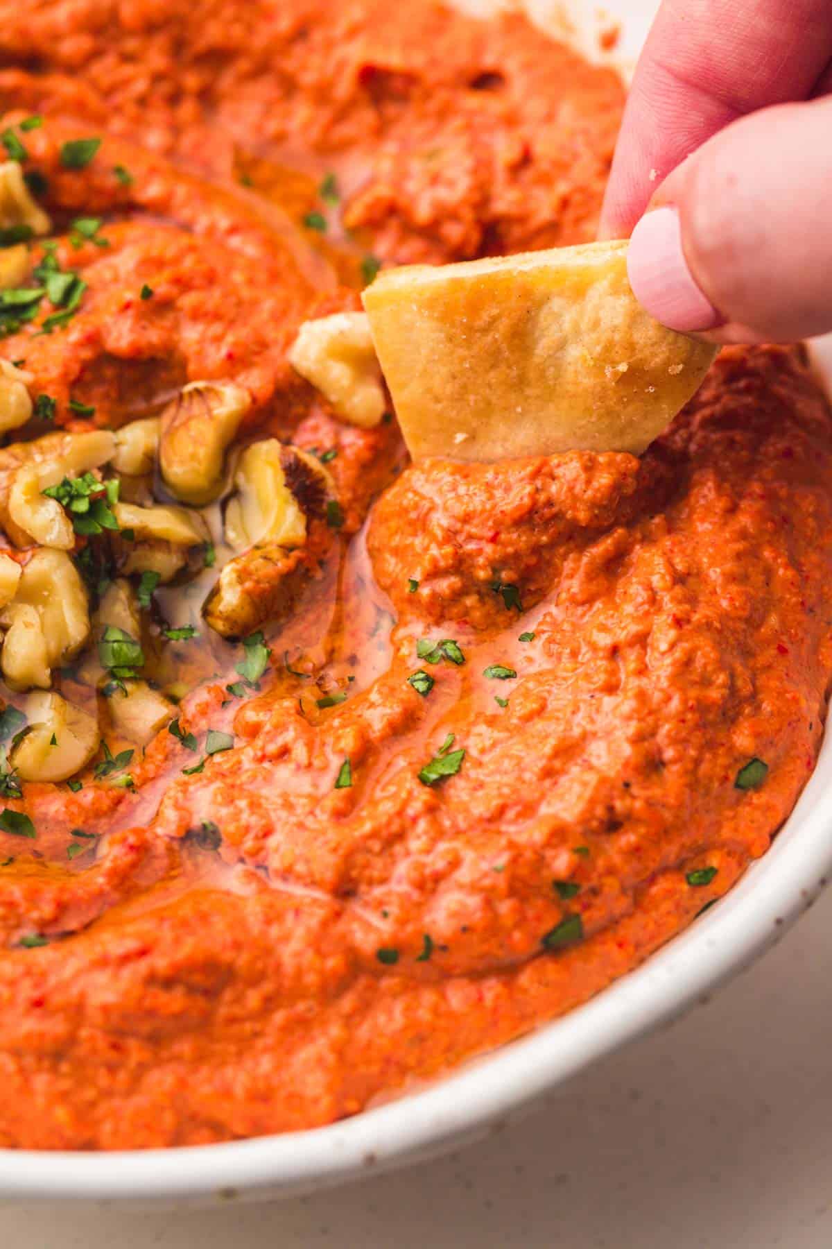 Eating muhammara with toasted pita chips