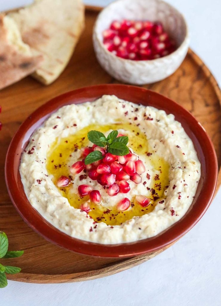 a bowl of Mutabbal eggplant dip with pomegranate seeds