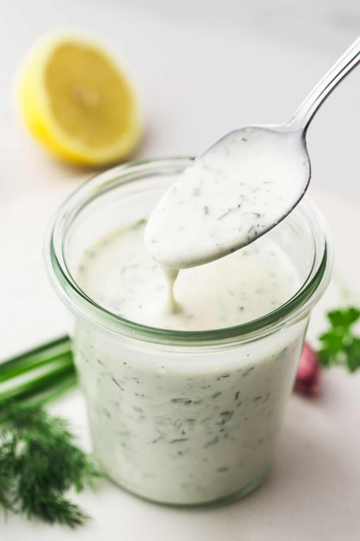 Weck jar filled with homemade ranch dressing, and a small spoon.