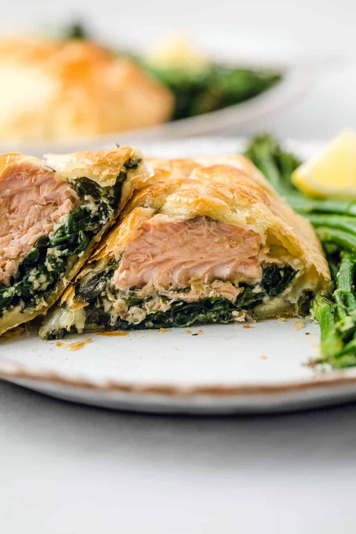 Cutting through the salmon wellington to see the perfect layering of the ingredients
