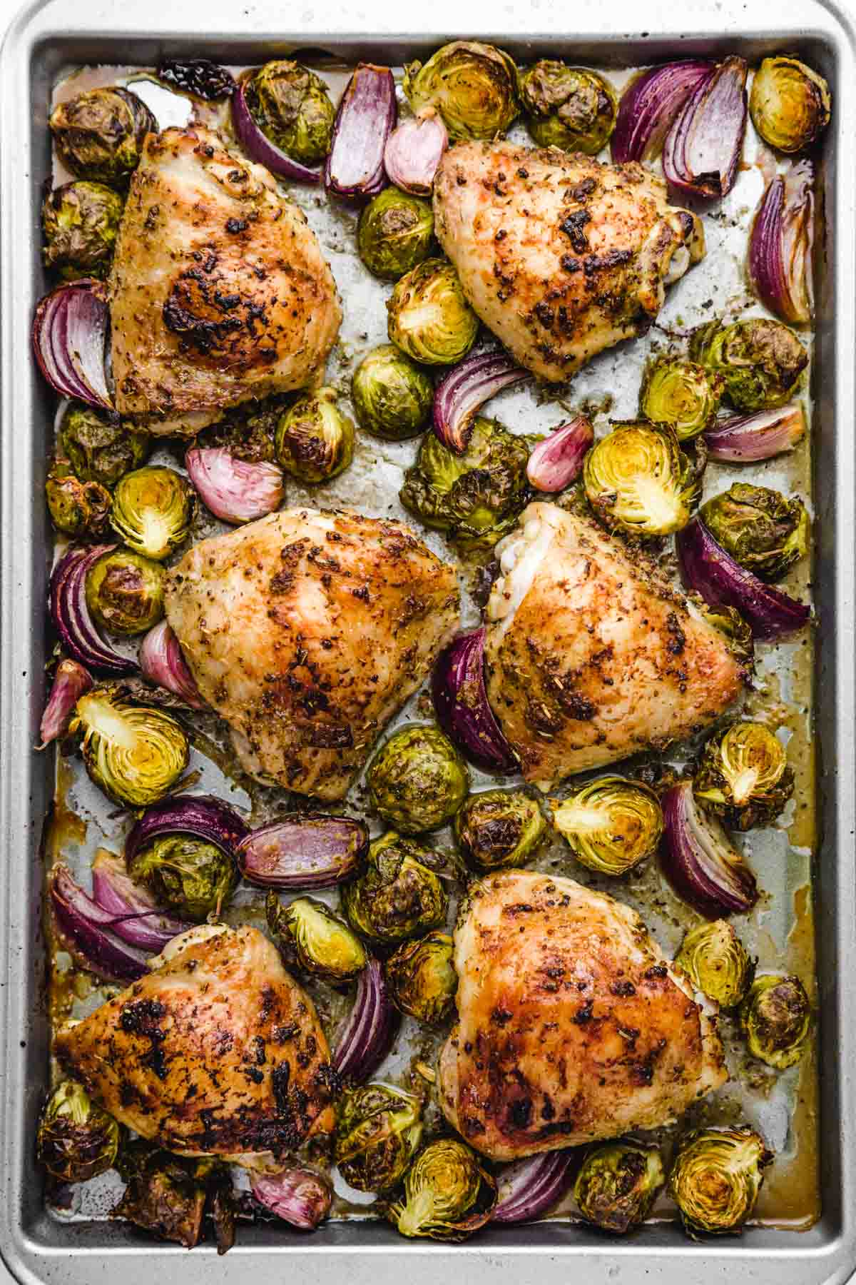 Roasted chicken and brussels sprouts on a sheet pan