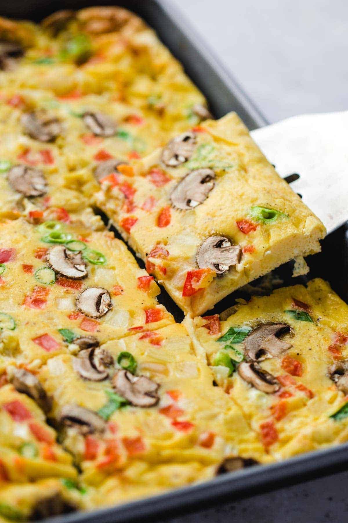 Taking a portion of sheet pan eggs from the sheet pan