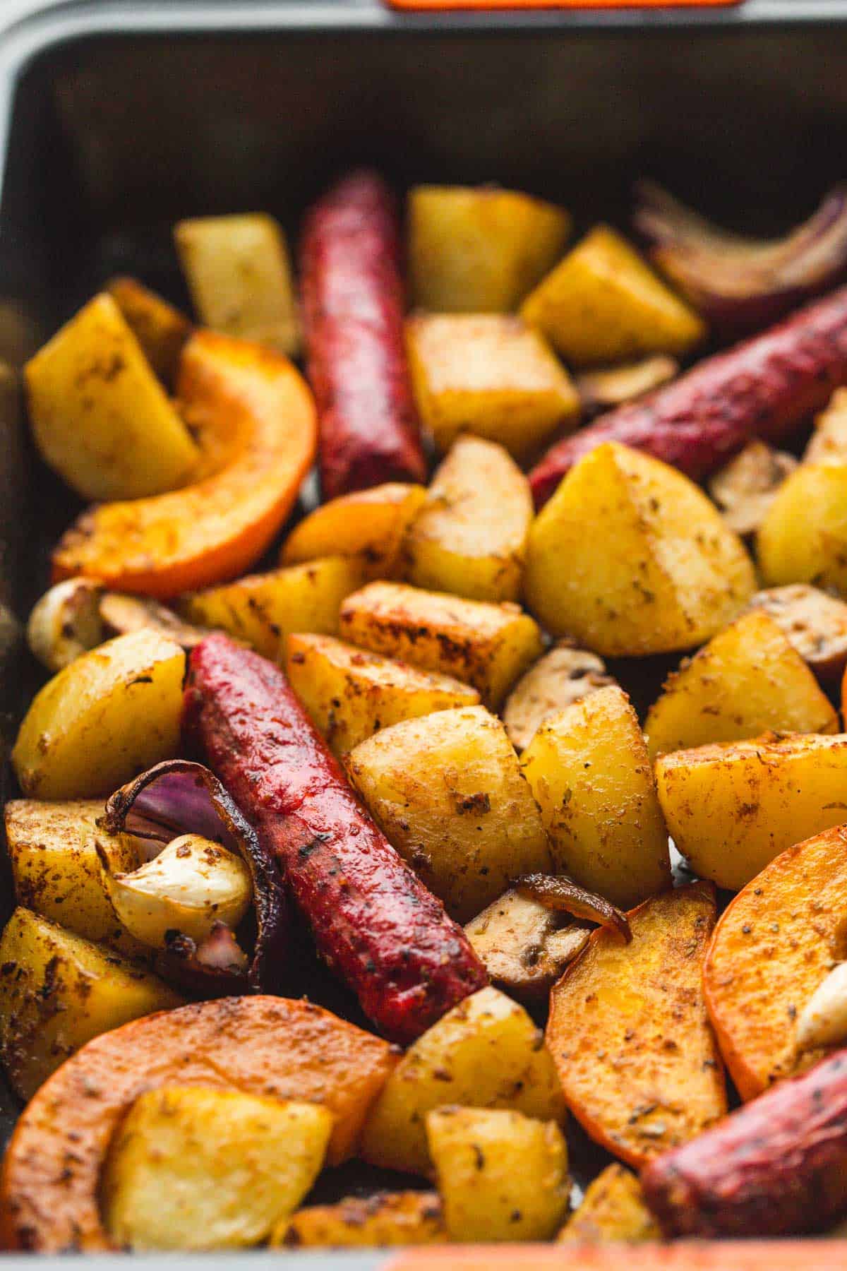 A close up shot of a cooked sausage and potatoes