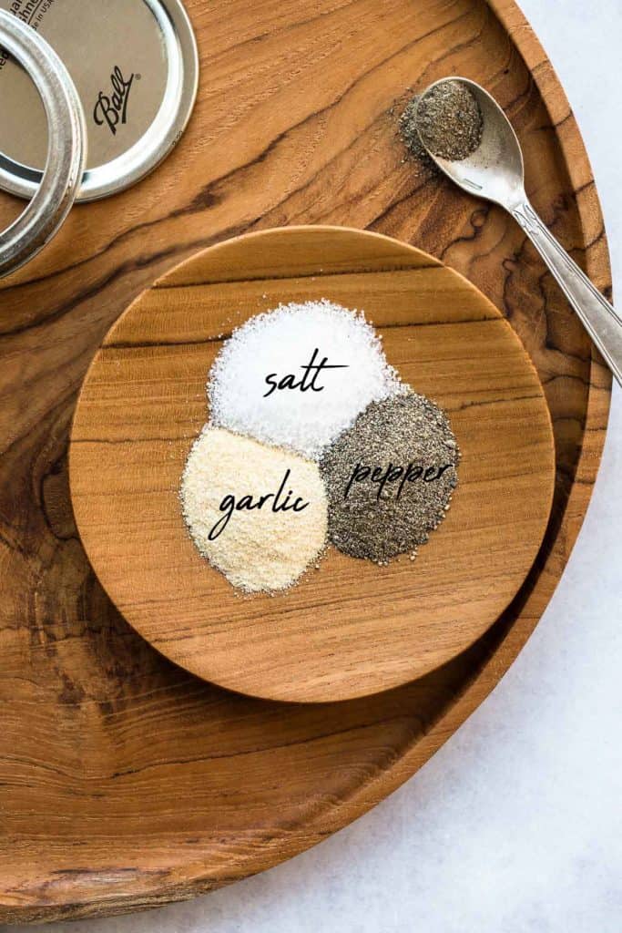 Stone House Seasoning ingredients on a wooden plate