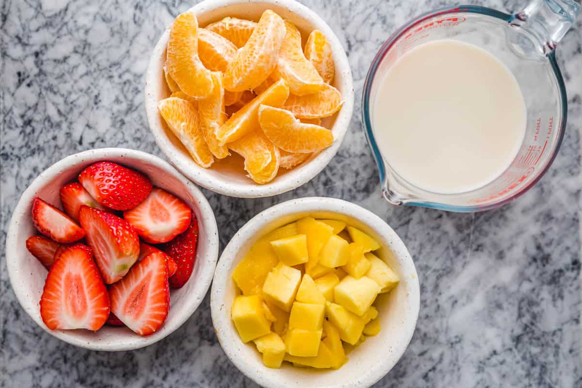 Strawberry Mango Smoothie prepped ingredients in bowls