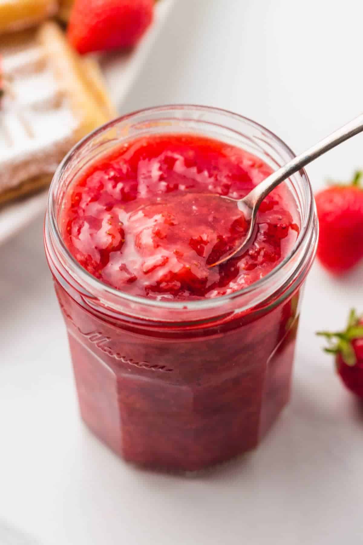 A jar of strawberry sauce