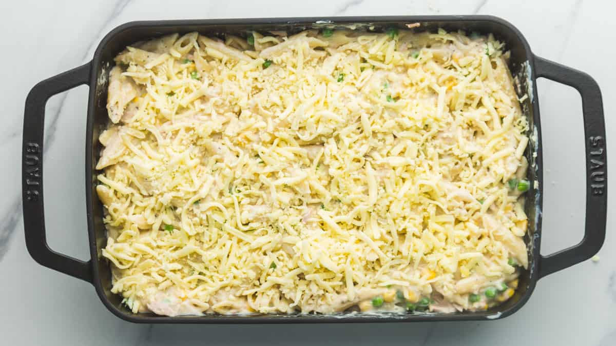 Staub cast iron baking dish with tuna pasta bake layers before going in the oven