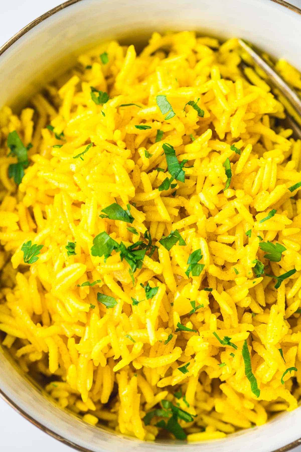 A close up shot of Turmeric Rice in a white bowl