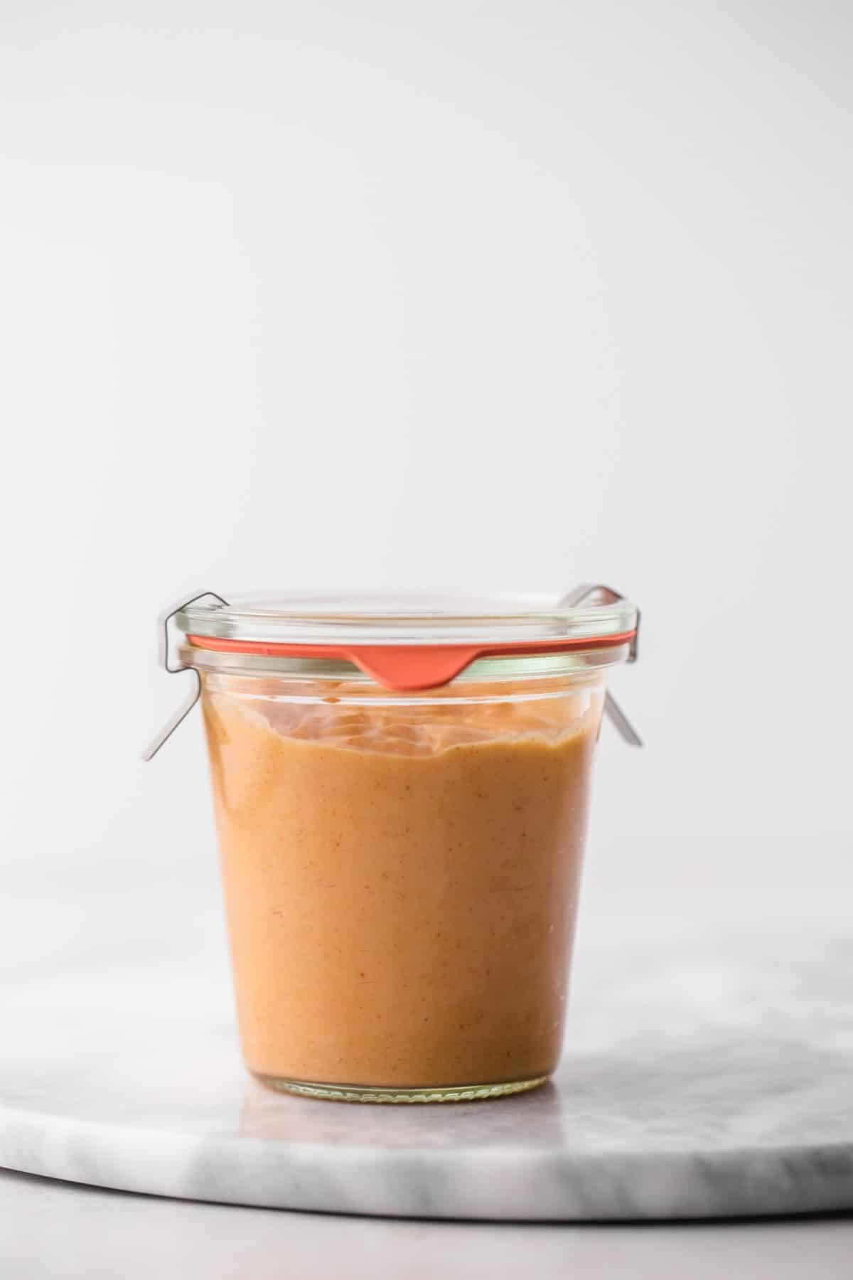 A Weck jar with yum yum sauce on a marble board