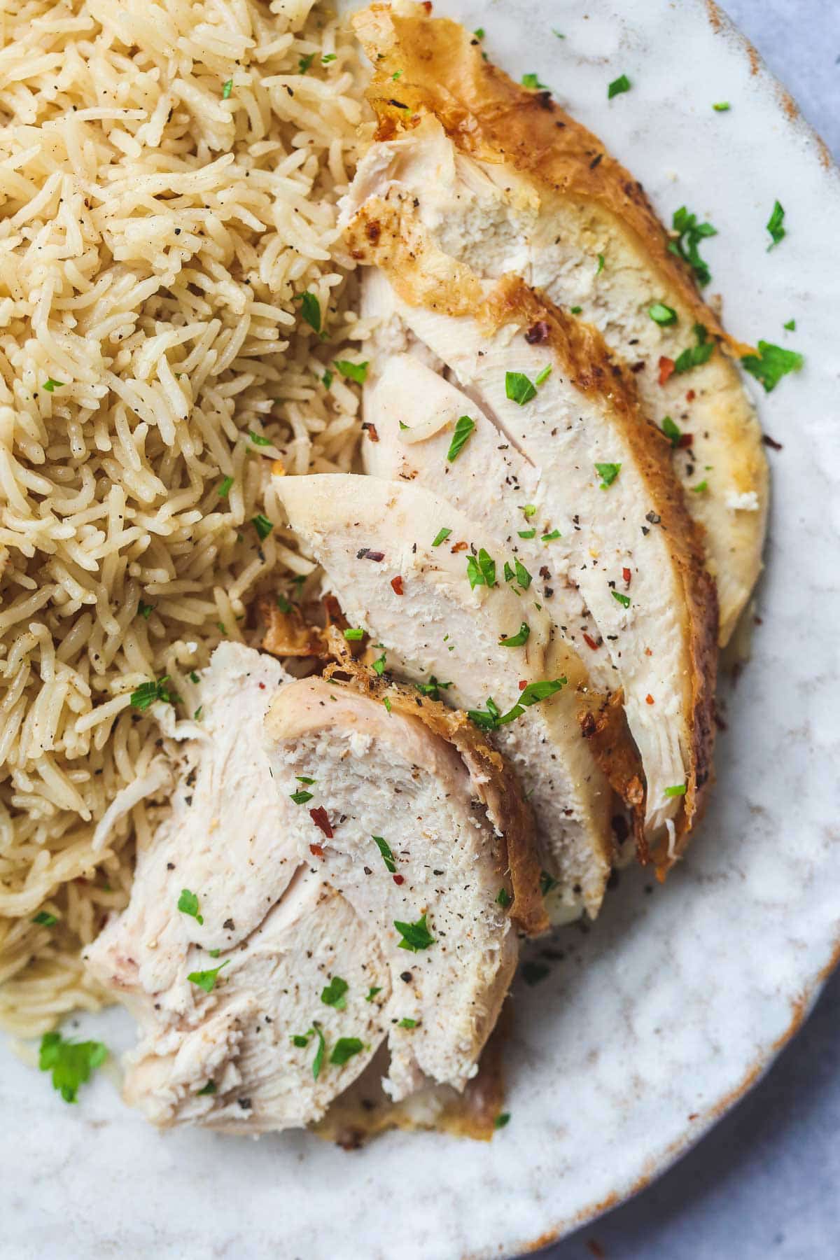 Perfectly cooked chicken sliced that were cooked in the instant pot, served with rice